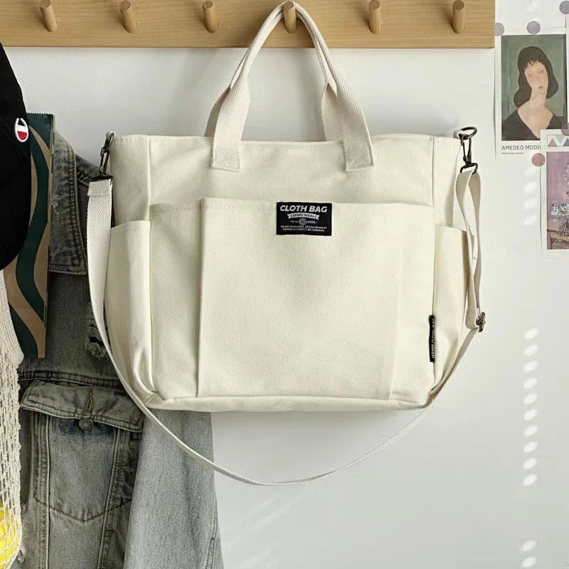 Urban minimalist portable student handbag, horizontal canvas, large capacity, one-shoulder diagonal crossbody bag.